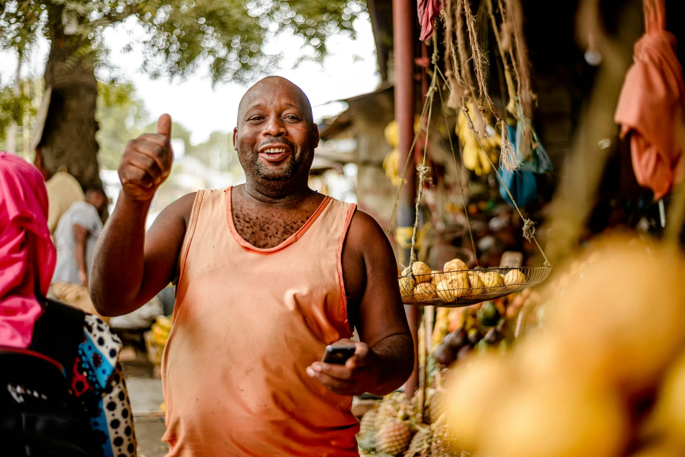 A trader at his fruit stand.